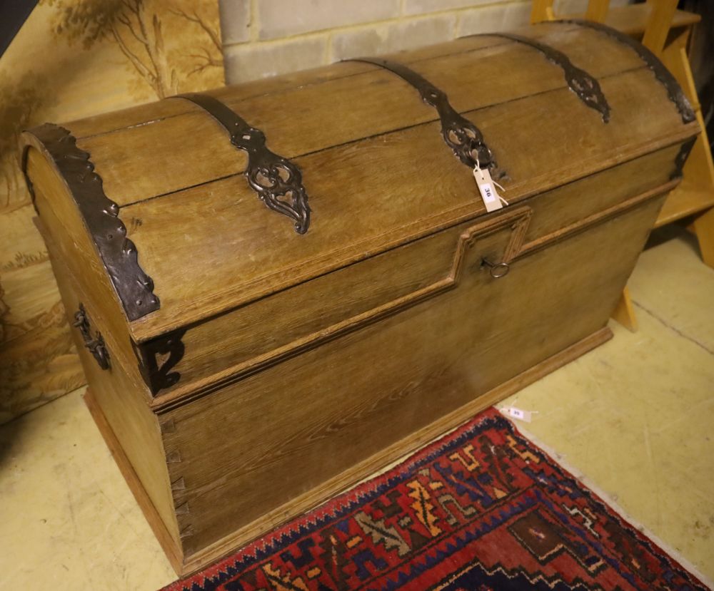 A 19th century pine dome top iron-bound travelling trunk/blanket chest on bun beet, width 128cm, depth 61cm, height 77cm